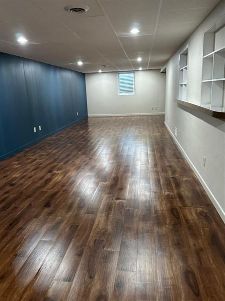 Finished basement with polished wood floor, move-out clean