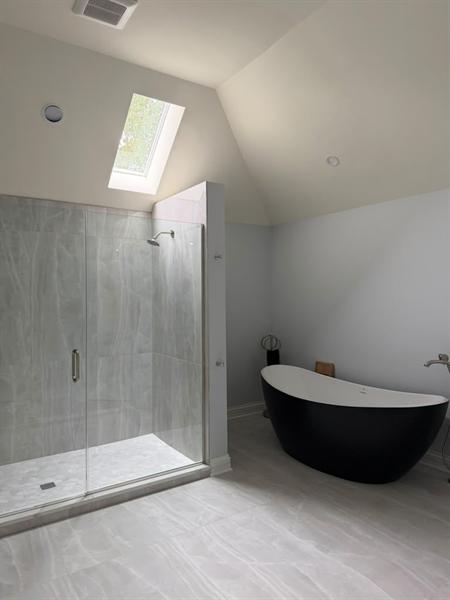 Remodeled bathroom with freestanding tub and walk-in shower cleaned