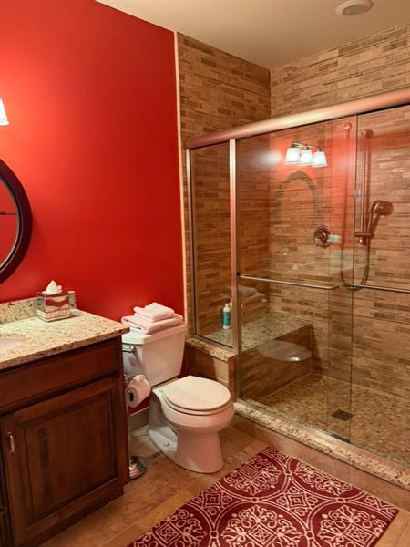 Remodeled guest bathroom with tiled shower cleaned